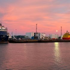 Ships at dock during sunset